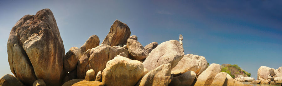 Low angle view of rock formation against sky