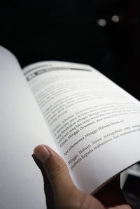 Close-up of hand holding book