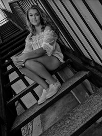 Portrait of woman sitting on staircase