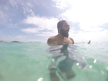 Portrait of man swimming in sea