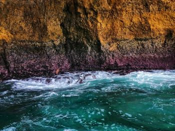 Scenic view of sea against rock formation