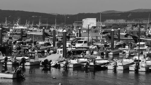 High angle view of boats moored at harbor against buildings