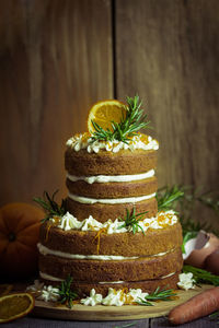 Cake on wooden table against wall