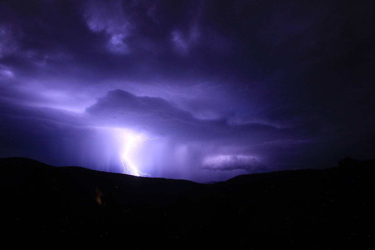 lightning, cloud, sky, storm, power in nature, beauty in nature, thunderstorm, night, darkness, environment, thunder, dramatic sky, mountain, scenics - nature, storm cloud, warning sign, nature, dark, no people, landscape, silhouette, sign, awe, outdoors, purple, communication, mountain range, atmospheric mood