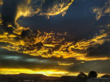 Low angle view of dramatic sky during sunset