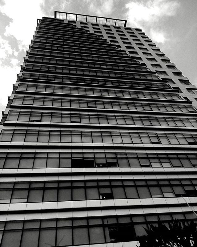 architecture, building exterior, low angle view, built structure, sky, modern, office building, building, city, tall - high, window, glass - material, skyscraper, cloud - sky, tower, reflection, day, outdoors, no people, cloud