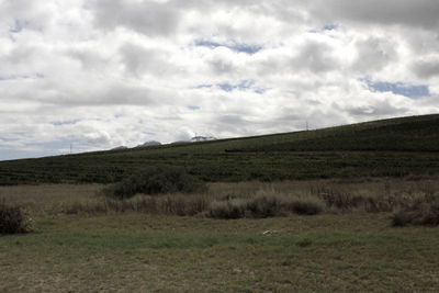 Scenic view of landscape against cloudy sky