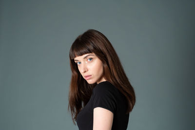 Portrait of woman against white background