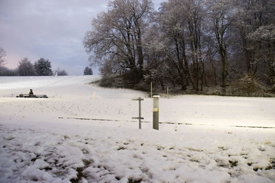 Snow covered field against sky