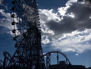 Low angle view of ferris wheel against sky