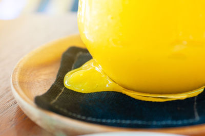 Close-up of yellow drink on table