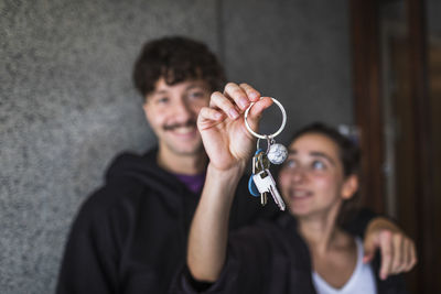 Couple showing keys to new apartment