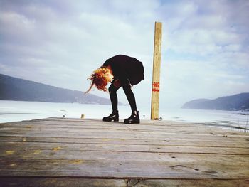 Full length of person on snow in sea against sky