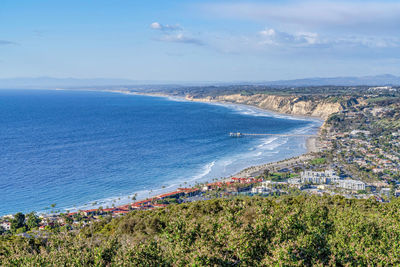 High angle view of sea and cityscape against sky