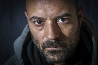 Close-up portrait of man wearing hooded shirt