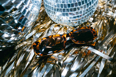 Close-up of sunglasses with disco balls.