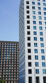 Low angle view of modern building against blue sky