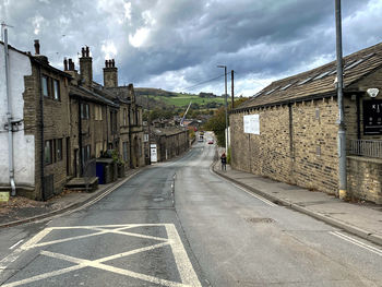 Looking along, burnley road, with old buildings, and rain clouds in, mytholmroyd, sowerby bridge, uk