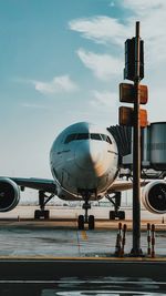 Airplane on airport runway against sky