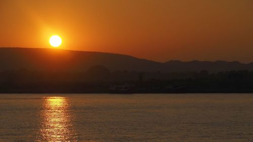 Scenic view of sea against orange sky