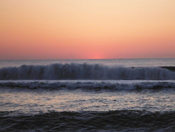 Scenic view of sea against clear sky during sunset