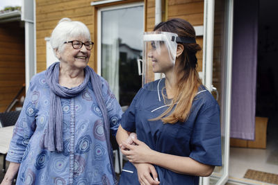 Nurse walking with elderly woman