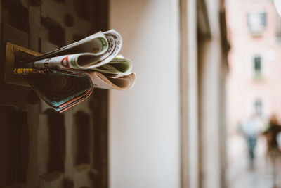 Close-up of newspaper on door