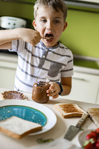 Boy eating food at home