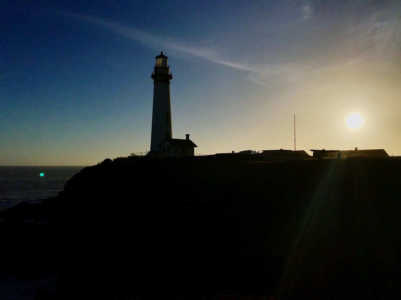 SILHOUETTE OF LIGHTHOUSE AGAINST SKY