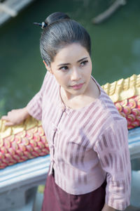 High angle view of woman standing by railing on staircase