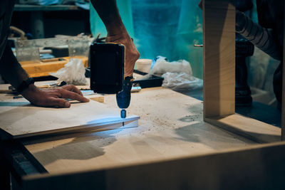 Midsection of man working at workshop