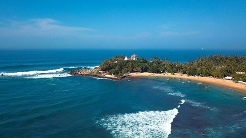 Scenic view of sea against blue sky