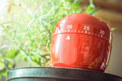 Close-up of red container with numbers on table