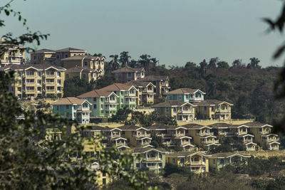 Houses in town against clear sky