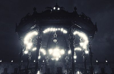 Low angle view of illuminated lights at night