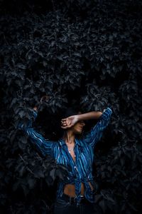 Woman standing against plants