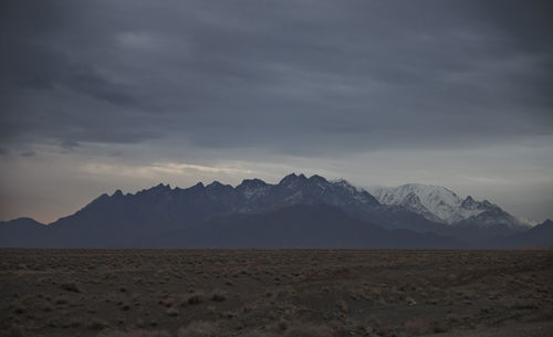 Scenic view of arid landscape against sky