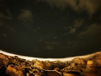 Low angle view of statue against sky at night
