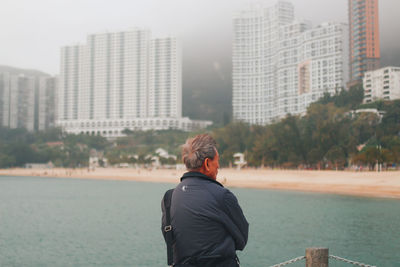 Rear view of man standing in front of building