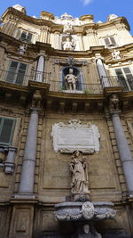 Low angle view of statue against building