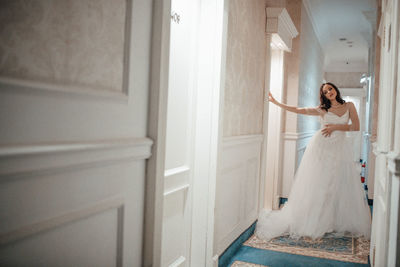 Woman standing by door at home