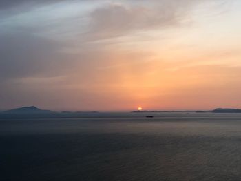 Scenic view of sea against romantic sky at sunset
