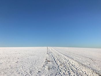 Scenic view of desert against clear blue sky