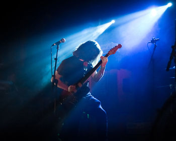 Man playing guitar at music concert