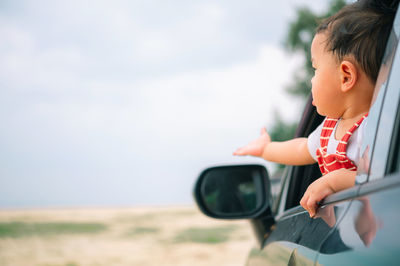 Rear view of boy looking at camera