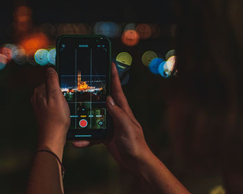 Midsection of man using smart phone