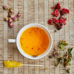 Directly above shot of fresh red flowers in bowl on table