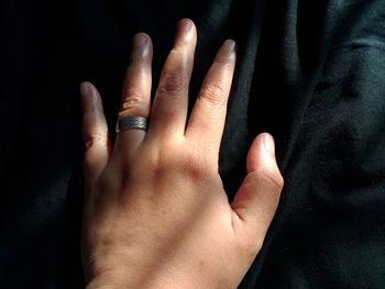 Cropped hand of person touching fabric