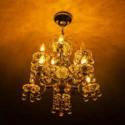 Illuminated chandelier hanging on ceiling