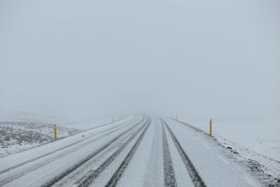 View of railroad tracks against clear sky during winter